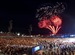 Fans watch a fireworks display at the end of Coldplay Concert