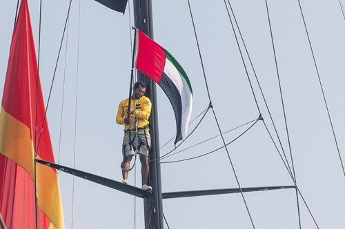 Abu Dhabi Ocean Racing's Adil Khalid waves the UAE flag as Azzam leaves Abu Dhabi on Leg 3 of the 2014 15 Volvo Ocean Race- Photo by Ian Roman.jpg